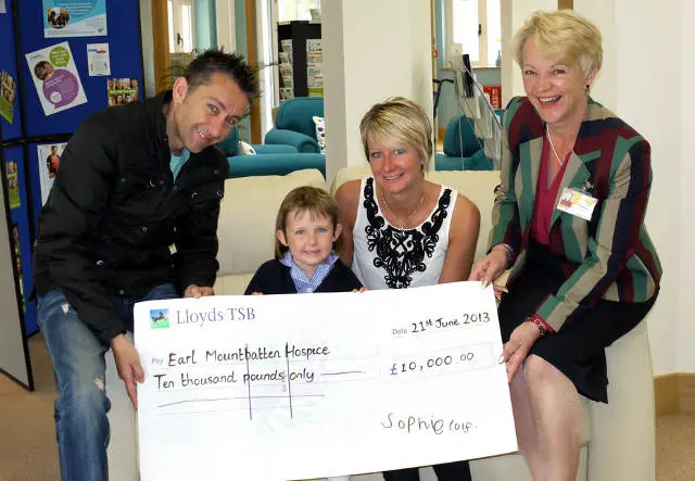 Sophie and family with cheque:
