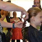 Emilie having her ponytail cut