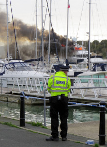 Police on the scene Kahu motor yacht fire in East Cowes by Anthony Joyce