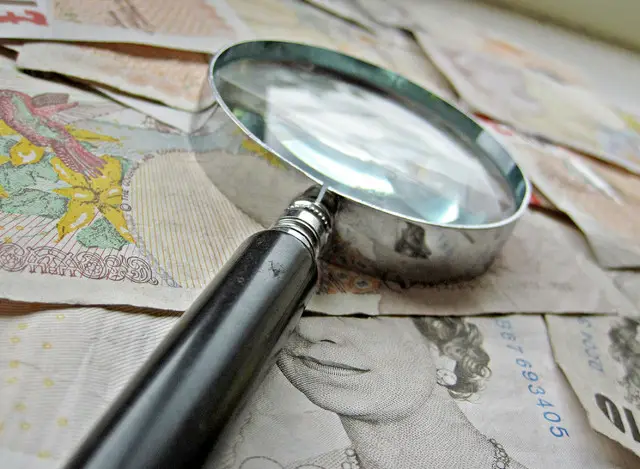 Money and magnifying glass