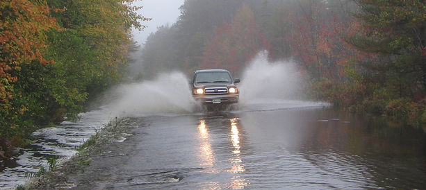 Car driving on flooded road: