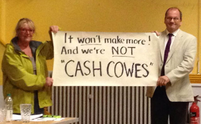 Cash Cowes Banner at public meeting