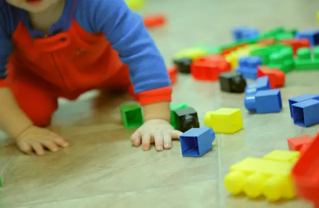 Toddler playing with colourful toys
