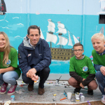 The launch of the 1851 Trust. Portsmouth. UK. Admiral Lord Nelson School pupils and Sir Ben Ainslie pictured painting HMS Victory on the walls of the new Ben Ainslie Racing HQ