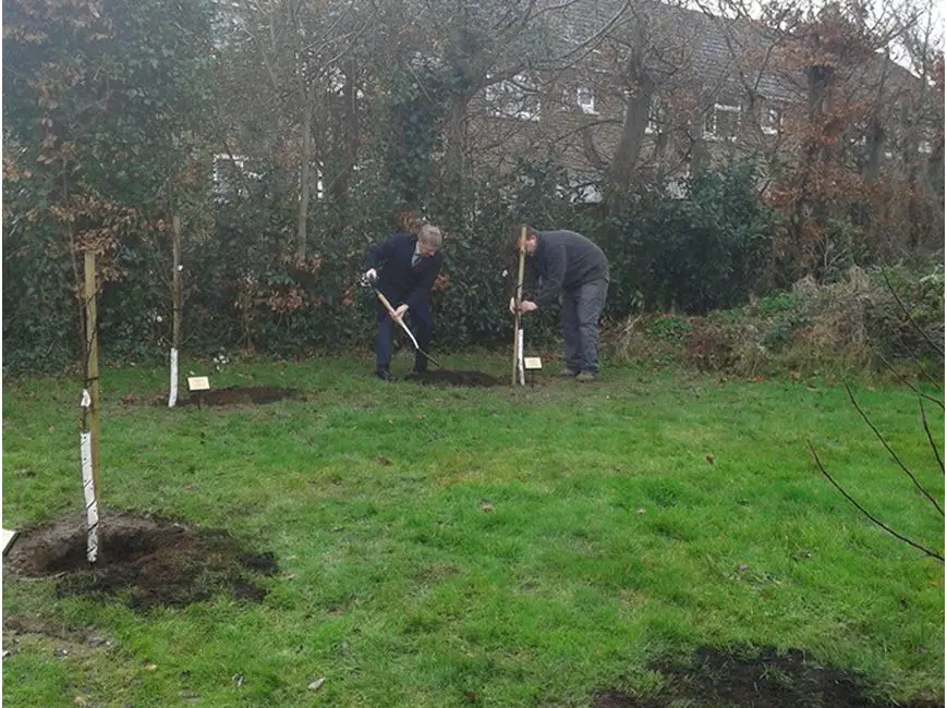Cllr Gordon Kendall planting a tree at Lane End Cemetery