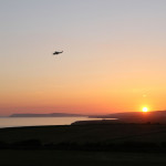 Blackgang rescue 7 June 2015 - Coastguard helicopter high in sky with Sunset by Chale Bay Farm