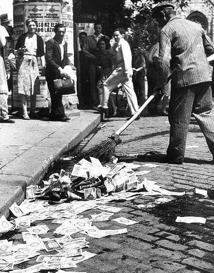 Sweeping up the banknotes from the street after the Hungarian pengo was replaced in 1946