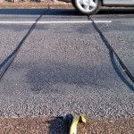 Traffic monitor cables with car driving over it - 632px