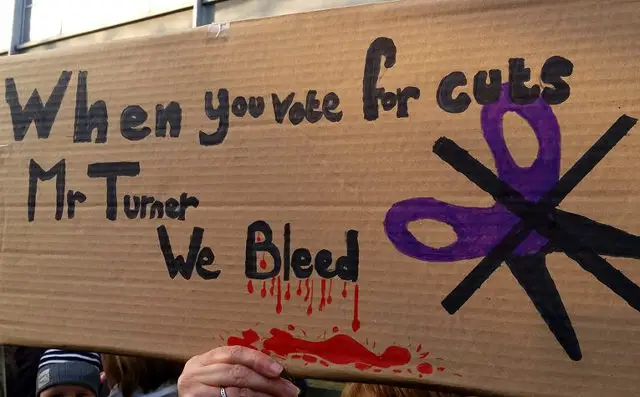cuts make us bleed banner