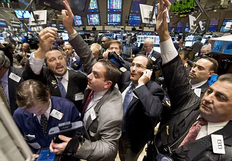 Traders crowd the post that handles Morgan Stanley on the floor of the New York Stock Exchange near the close of trading, Wednesday Sept. 17, 2008. The Dow Jones industrial average dropped about 450 points, and investors seeking the safety of hard assets and government debt sent gold, oil and short-term Treasury's soaring.