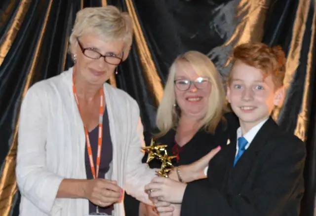 Kieron Haigh, age 12, receiving his award from the Chair of Governors, Lesley Holmes.