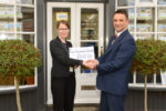 Bembridge, HRD Estate Agents Office, Left, Jax Jones from EMH being presented with £250 from Philip Weeks of HRD
