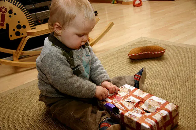 Toddler unwrapping present
