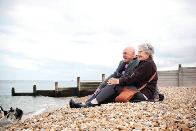 Elderly couple sitting on the beach