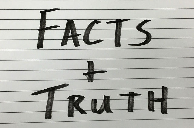 facts and truth written on paper