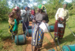 Rotary barrels of water with elderly women