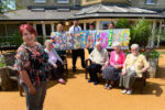 Nicky Shepherd with staff displaying residents' outstanding handiwork