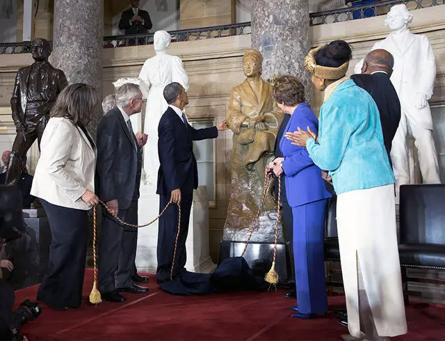 President Barack Obama touches the Rosa Parks statue after the unveiling during a ceremony in Statuary Hall at the U.S. Capitol in Washington, D.C., Feb. 27, 2013. Helping with the unveiling, were, from left:  Sheila Keys, niece of Rosa Parks; Senate Majority Leader Harry Reid, D-Nev.; House Speaker John Boehner, R-Ohio; Leader Rep. Nancy Pelosi, D-Calif.; Assistant Leader Rep. James Clyburn, D-S.C.; and Elaine Eason Keys