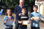 Cllr Jon Boileau Goad, with the art contest winners, Amelia Mumford, 7, and her brothers, Ben, 9, centre, and Sam, 10.
