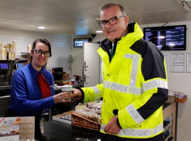 Wightlink’s Tara Broad serves coffee in a reusable cup to Chief Executive Keith Greenfield on board St Clare.