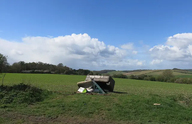 flytipping sofa in field
