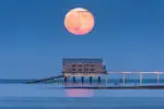 large red moon over lifeboat station