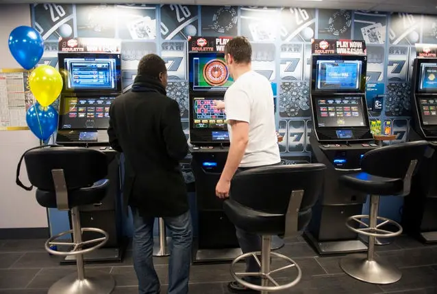 two men playing on fixed odds betting machine