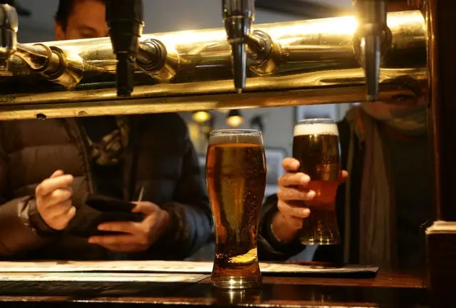 Pints being poured in a pub