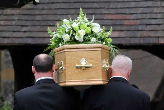 coffin being carried into church