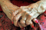 older woman crossing her hands