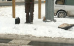 homeless man busking in the snow