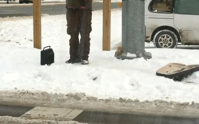 homeless man busking in the snow