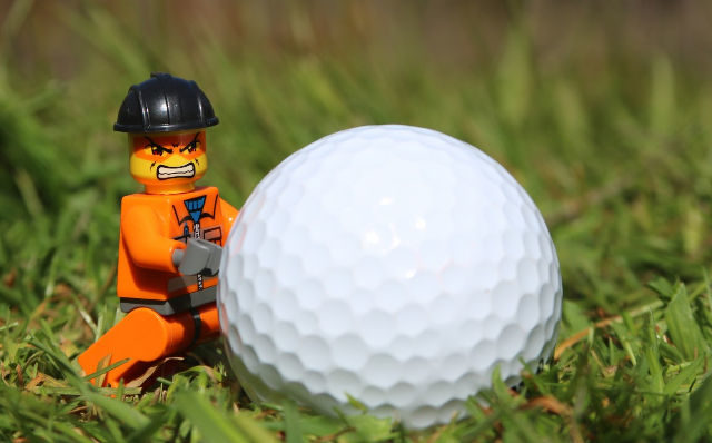 golf ball and toy with _angry_funny_toy_man_man_grass_face