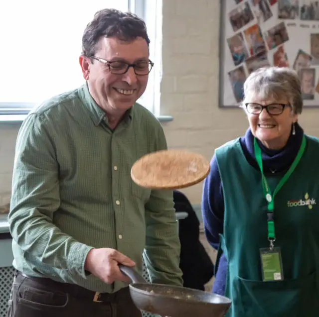 Cllr Lilley pancake flipping for IW Foodbank