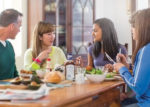 students and host family sat at dinner table