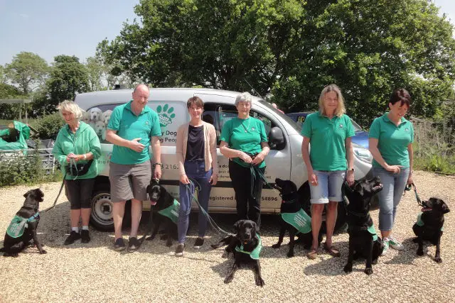 Volunteers and dogs standing by van