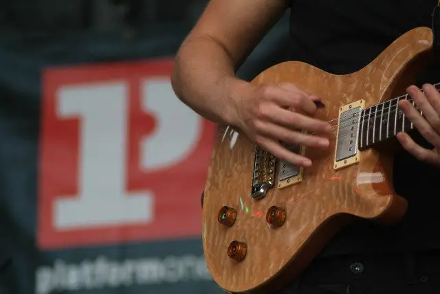 Platform one student playing on stage - close up of guitar
