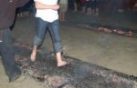 Someone walking over hot coals