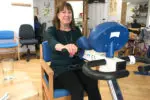 Anita sitting in a chair using the machine