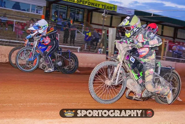Riders on motorbikes at Speedway race