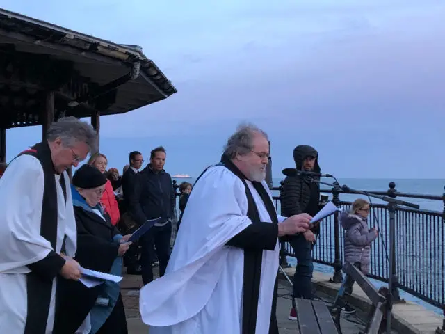 Prayers being read with MV Boudicca in the background