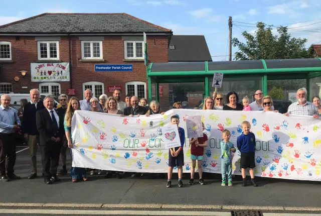 Freshwater parish councillors and pupils and parents with banner