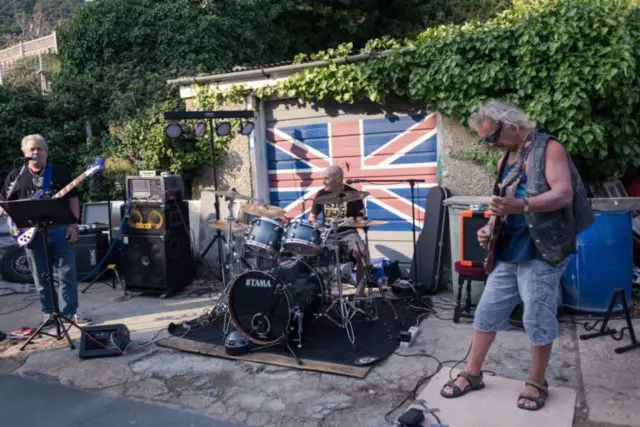 A band performs outside garage at Ventnor Fringe Festival