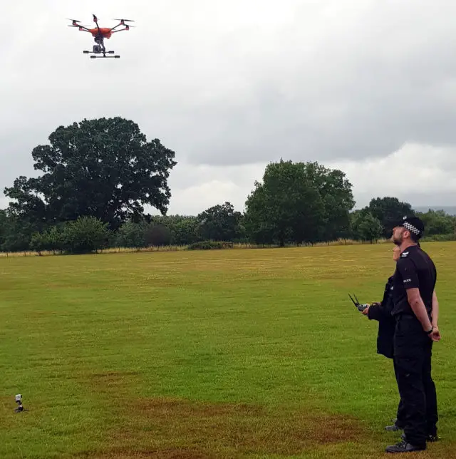 Police officers operating the drone