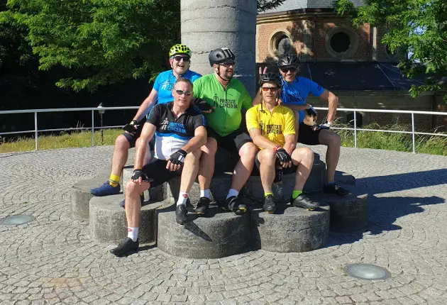 Ian Gregory and other cyclists stop for photo