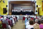 the choir on stage in front of an audience