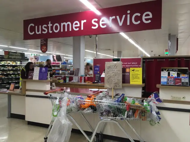 Trolleys filled with unwanted single use plastic left by customer service desk