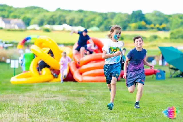 Children taking part in the inflatable rainbow run