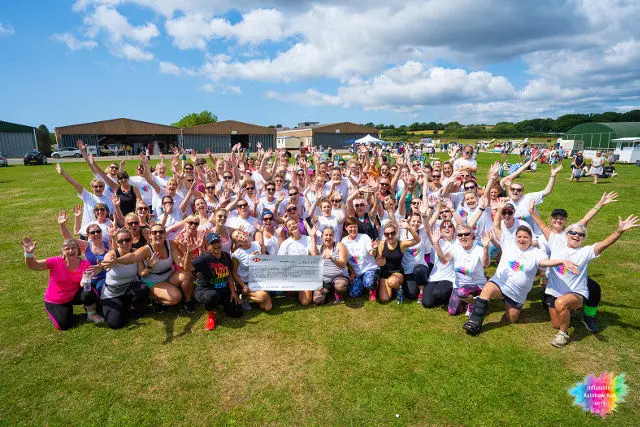 People who took part in Inflatable Rainbow Run for Wessex Cancer Trust pose for photo