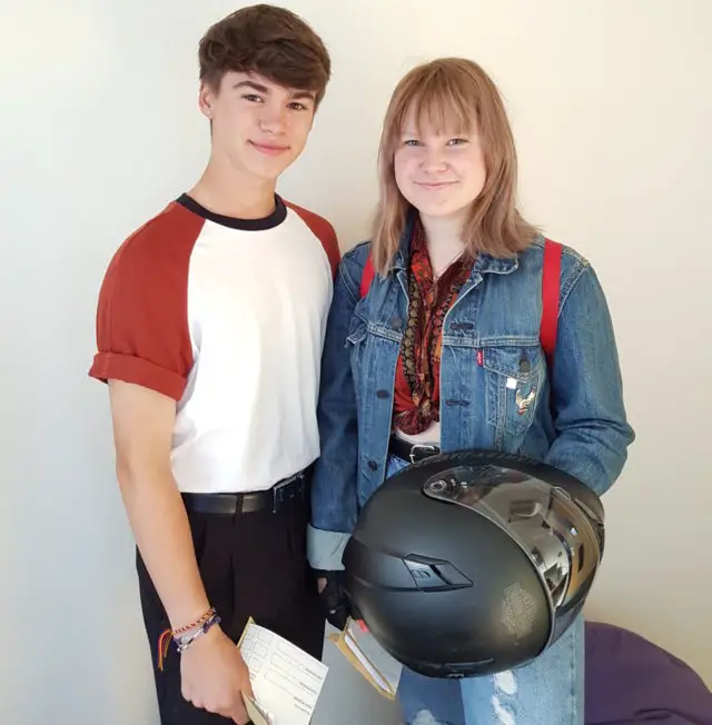 Male and female pupils celebrating their GCSE results